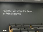 together we shape the future of manufacturing - written on wall