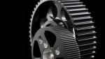 timing pulleys and gears on black backdrop